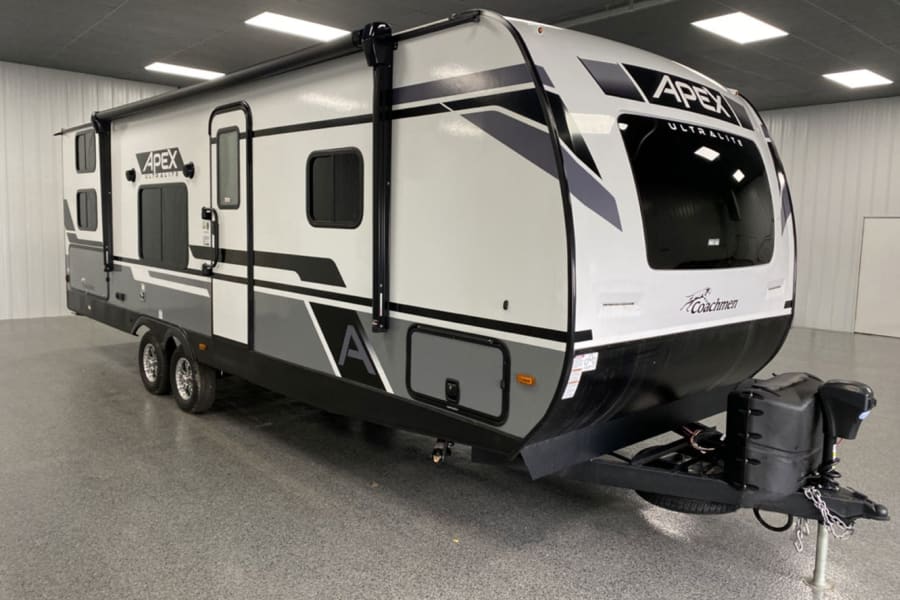 Front door-side quarter view of rig