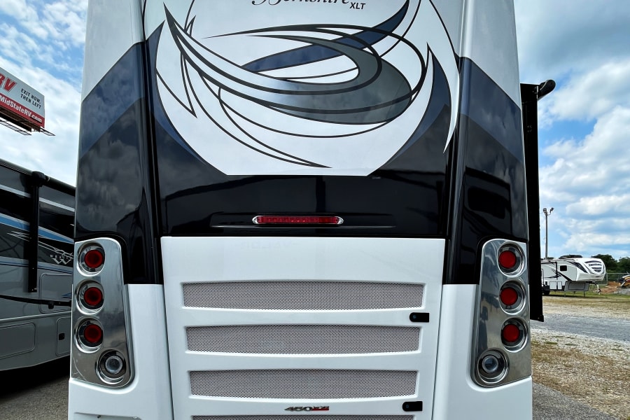 Rear view of a luxurious white and black Berkshire XLT motorhome, detailed for your next comfortable RV rental journey.