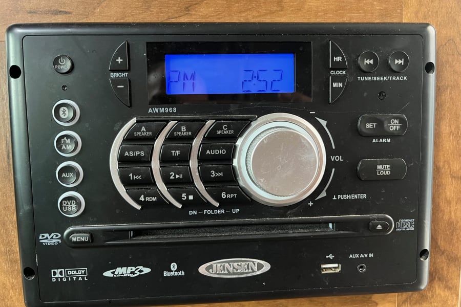 This Jensen AWM968 multimedia stereo, common in an RV rental, features DVD, USB, Bluetooth, and a digital clock.