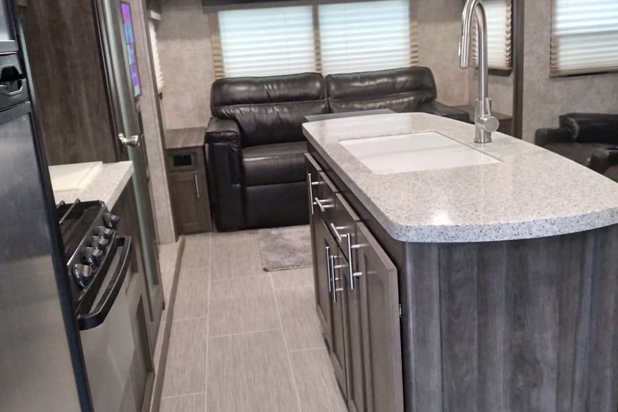 The shows the Kitchen  island with load of storage for dishes! Excellent prep area too!