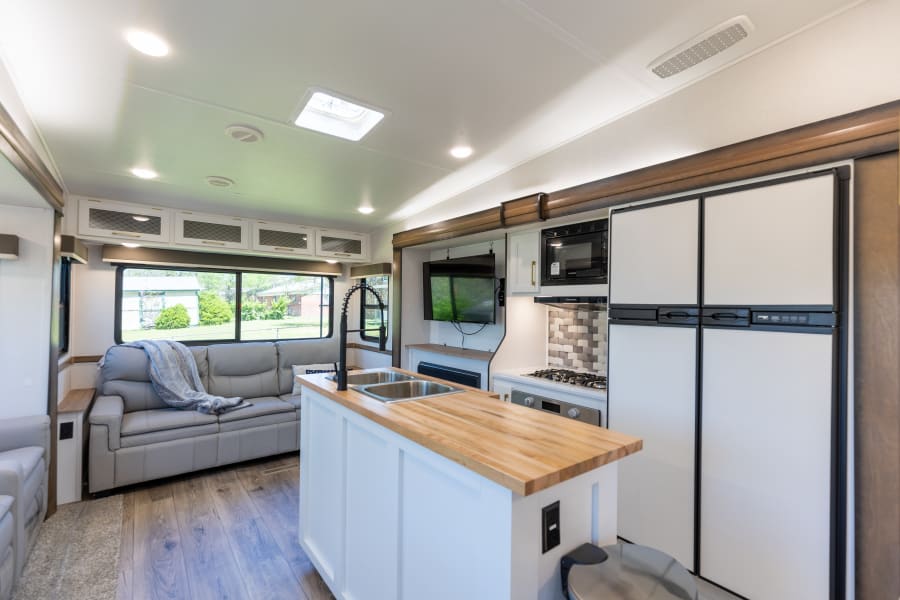Spacious fully stocked kitchen & living room with butcher block counters. Large 2 door refrigerator. Wide 3 seater couch. 