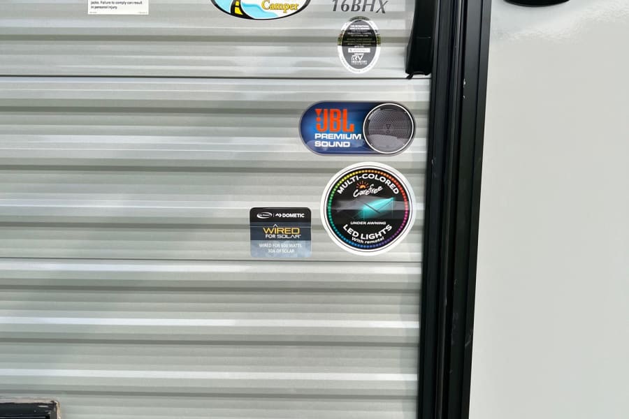 RV rental 16BHX camper side, featuring JBL audio, Dometic solar wiring, and LED lights for adventures and memories.