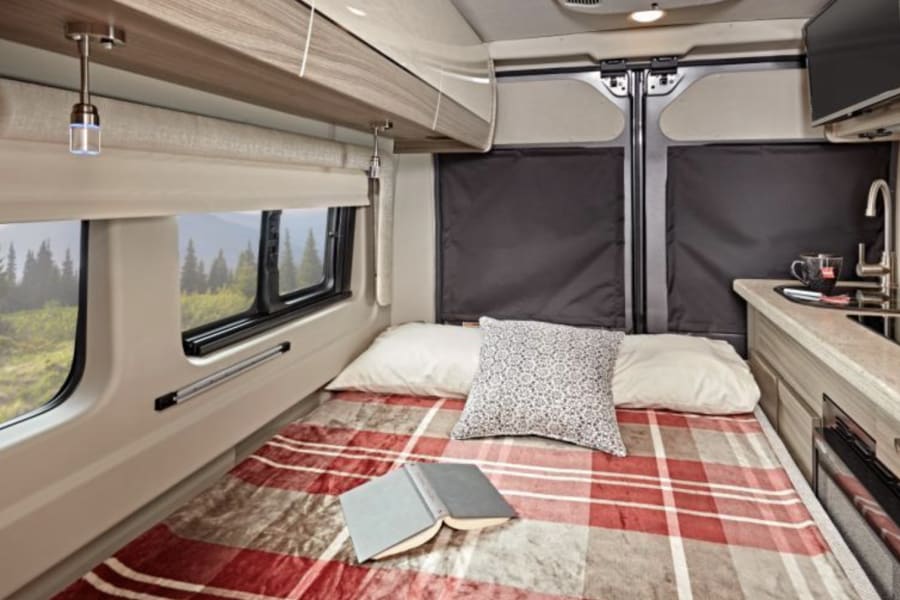 Sleeping area in the rear converted to a bed from a bench. 
