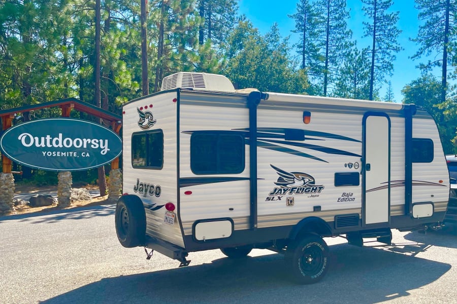 This Jayco travel trailer RV rental at Outdoorsy Yosemite, CA is ready for adventure! Parked under a sunny sky.