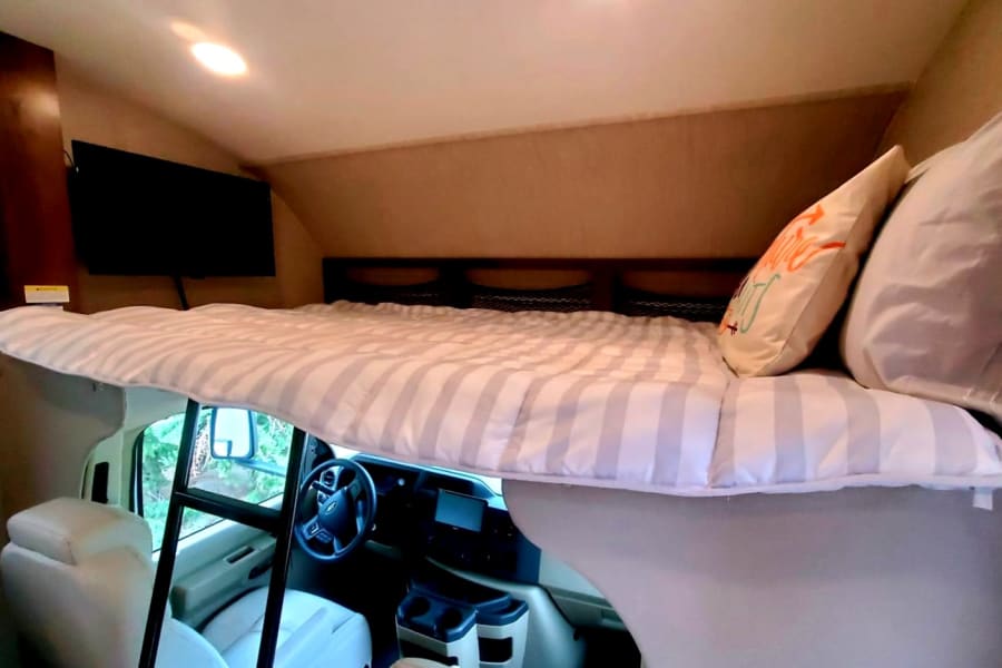 Overhead Bunkbed, equipped with big screen TV that swivels to face living area. 