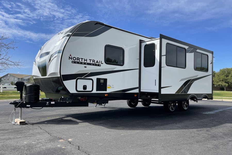 This North Trail Ultra Lite travel trailer, an ideal RV rental, offers extra space with its extended slide-out.