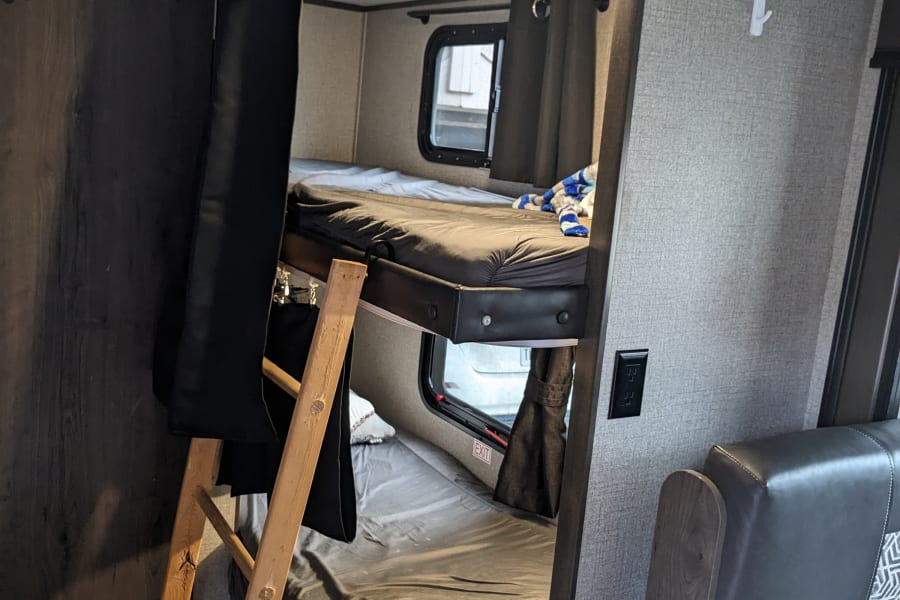 two twin bunk beds, ladder to get up to the second story, windows and curtains for both bunks. 