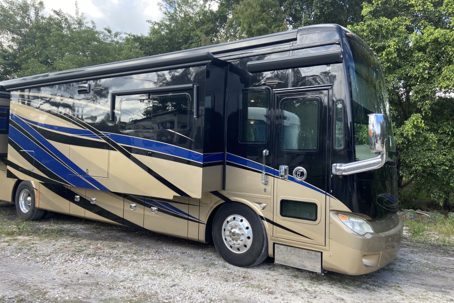 This elegant black and gold luxury RV is perfect for your next adventure. Explore the open road with our premium rv rental options.