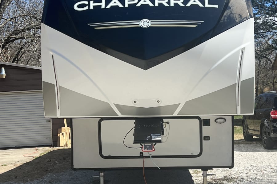 Front of a large, modern Chaparral fifth-wheel RV, ready for your next rv rental adventure and outdoor journey.