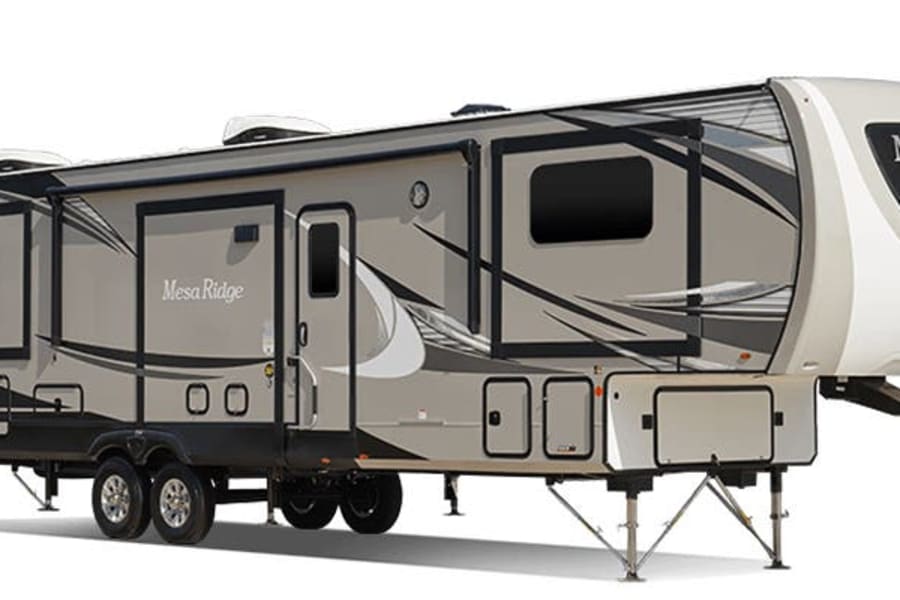 Modern Mesa Ridge fifth-wheel RV, ideal for an RV rental adventure, shown with extended slide-outs revealing spacious interiors.