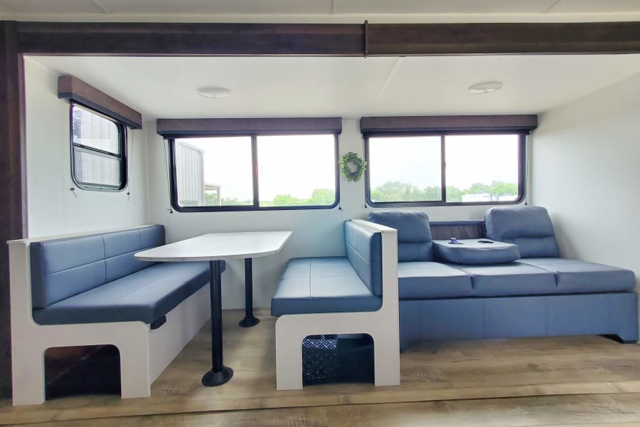 Table lays flat into bed, open storage under bench seats