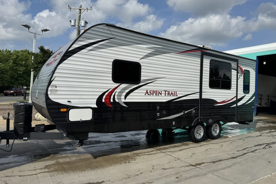 A clean Aspen Trail travel trailer after a wash, great for an rv rental.