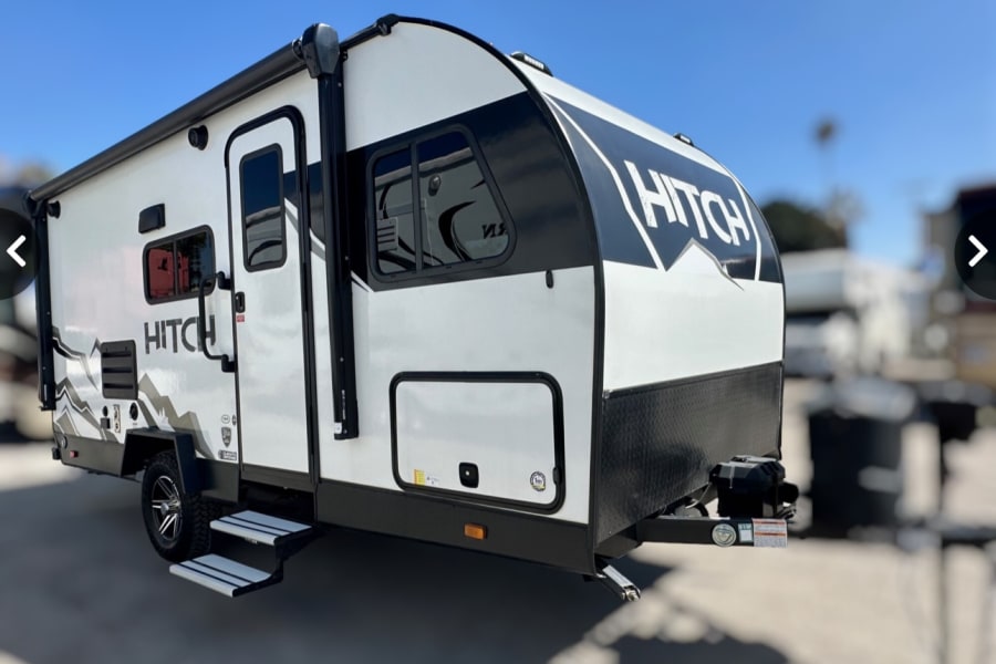 Modern white and black "Hitch" travel trailer, perfect for your next RV rental adventure.