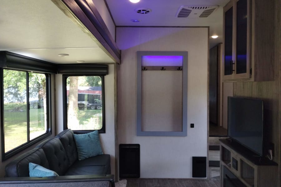 The enlarged couch area allows 3-4 people to comfortably watch a movie or relax by the fireplace