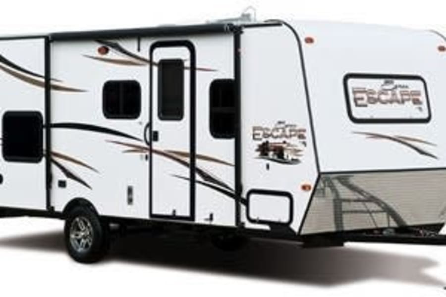 White travel trailer with 'Escape' branding, shown from the side. Ideal for an RV rental, offering comfort on the road.