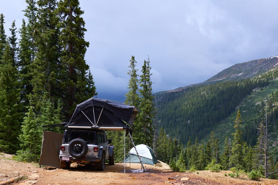 Overland camping setup with rooftop tent & ground tent, a great RV rental alternative in the mountains.