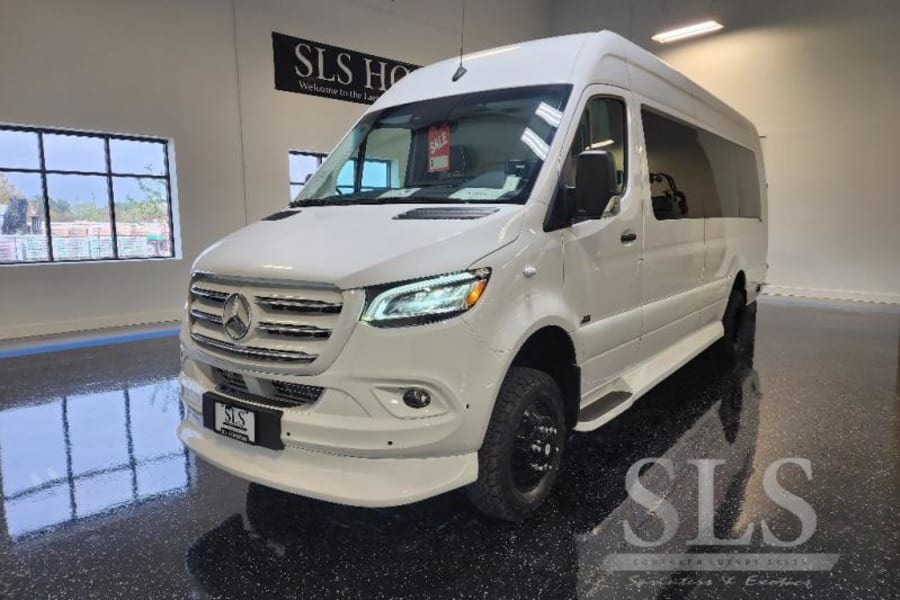 This white Mercedes Sprinter luxury RV rental van gleams in a showroom, ready for your next adventure.