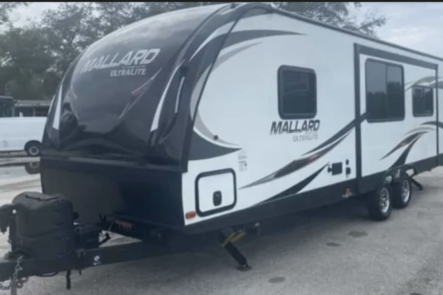 This white & black Mallard Ultralite travel trailer is ideal for your next rv rental. Perfect for camping adventures!