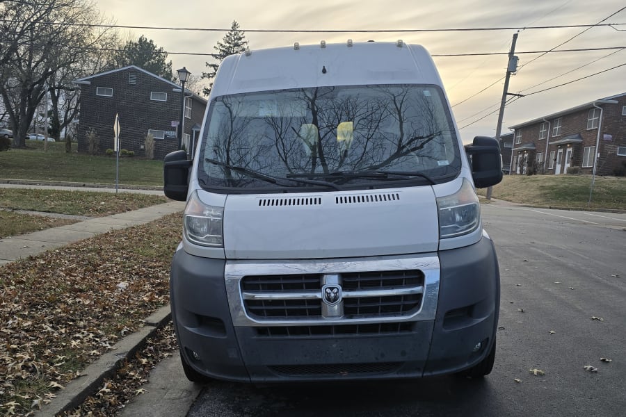 White Ram ProMaster van parked on a street with fall leaves. A popular choice for RV rental.