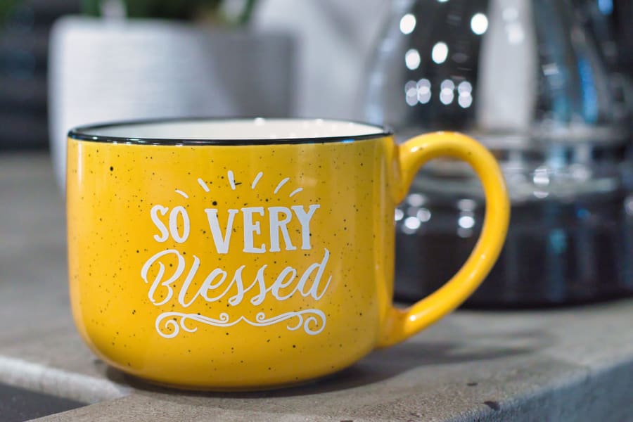 Enjoy morning coffee in this 'SO VERY Blessed' yellow speckled mug during your unforgettable RV rental vacation.