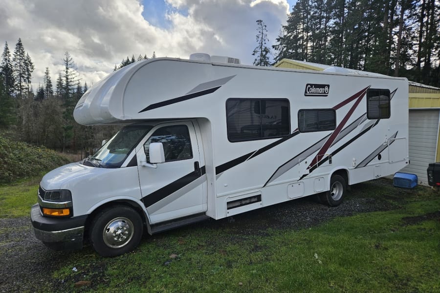 This white Coleman RV is perfect for your next adventure. Explore the outdoors with this spacious RV rental.