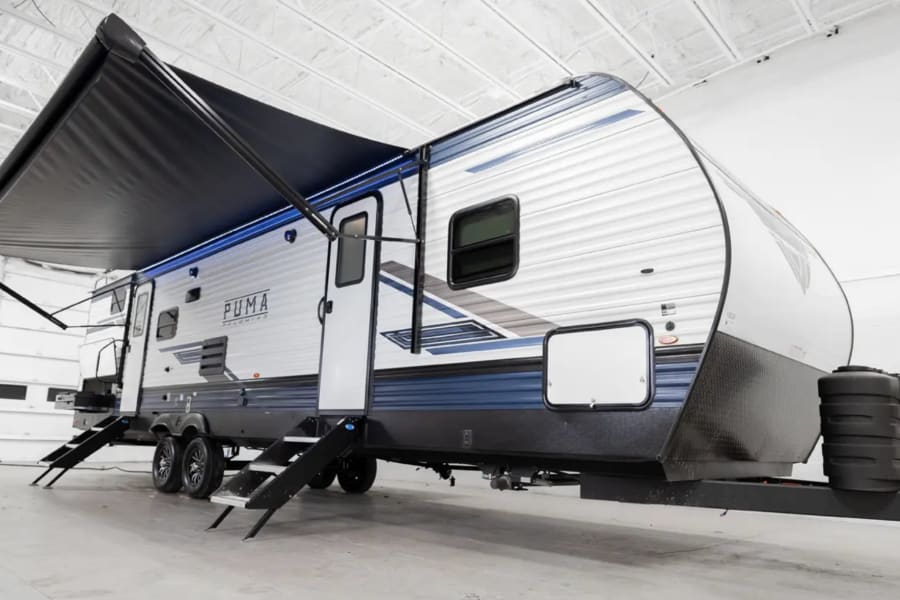 This PUMA travel trailer with an extended awning is ready for your next RV rental adventure.