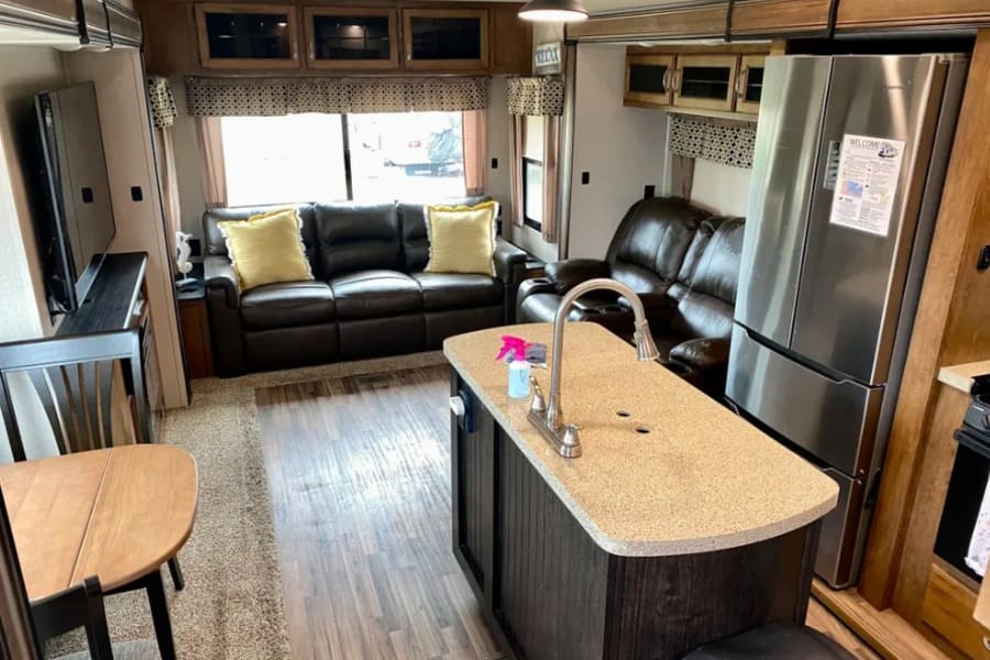 island kitchen, residential refrigerator, recliners, couch bed, big screen tv, family room