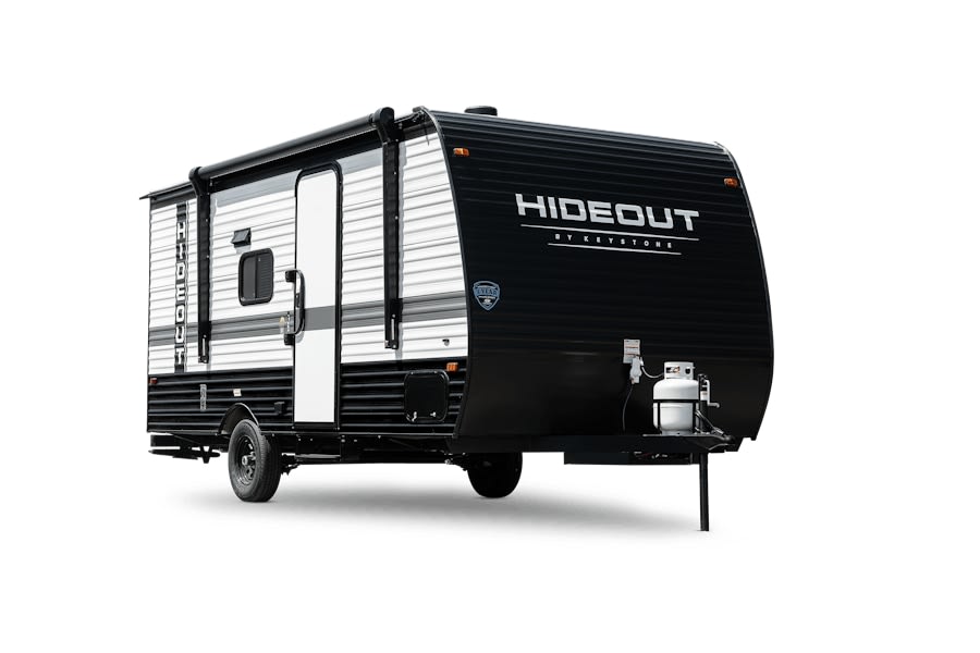 Black and white "Hideout" travel trailer, ideal for an RV rental adventure. Visible awning, door, propane tanks.