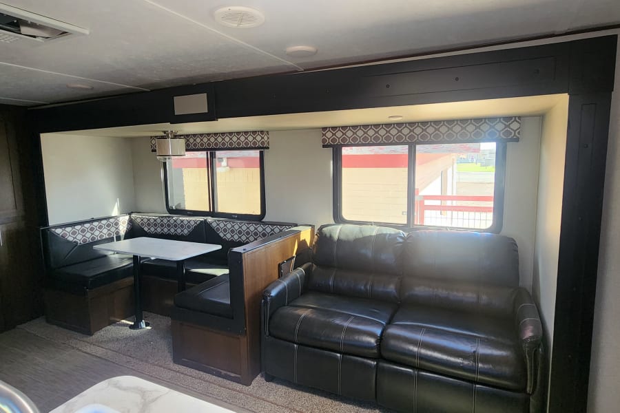 Livingroom area, couch will pull out to a full-size bed, dinette can be converted into sleeping area. 