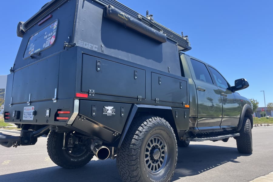 This robust truck camper, part of an RV rental fleet, is equipped for rugged overland trips.