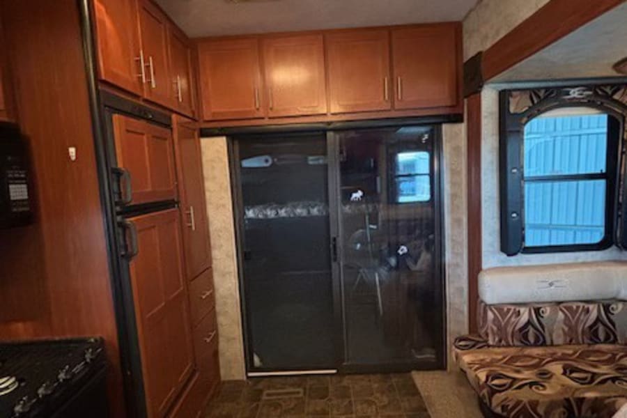 RV rental: Bright interior featuring a full kitchen, ample storage, and a comfy dining booth for your travels.