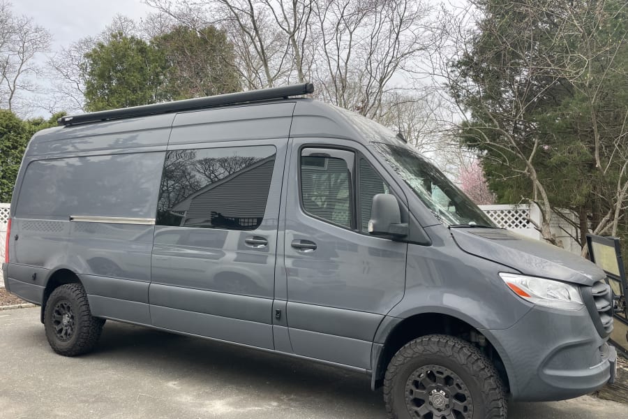 This gray Mercedes-Benz Sprinter van, an off-road camper for rv rental, is ready for your next adventure!