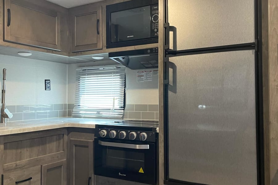 4 burner stove, oven and microwave.