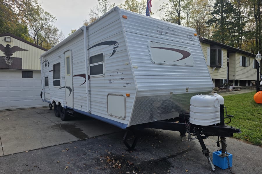 Jayco travel trailer (RV) parked in a driveway. Perfect for your next rv rental camping adventure!