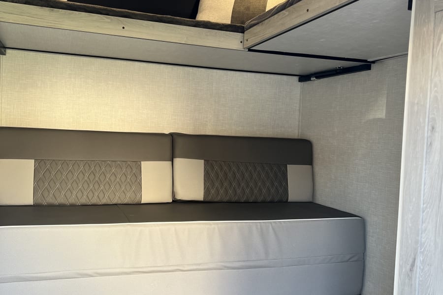 RV rental bunkhouse: modern design with upper bunks & a lower convertible sofa/bed.