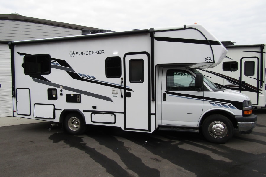 A white Sunseeker Class C RV with black & gray graphics. An ideal rv rental for your next adventure.