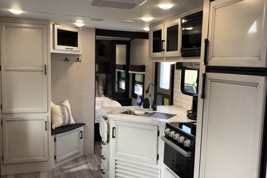 Showing how the master bedroom and kitchen feed into each other. The master bedroom has a large door that closes off the rest of the space. 