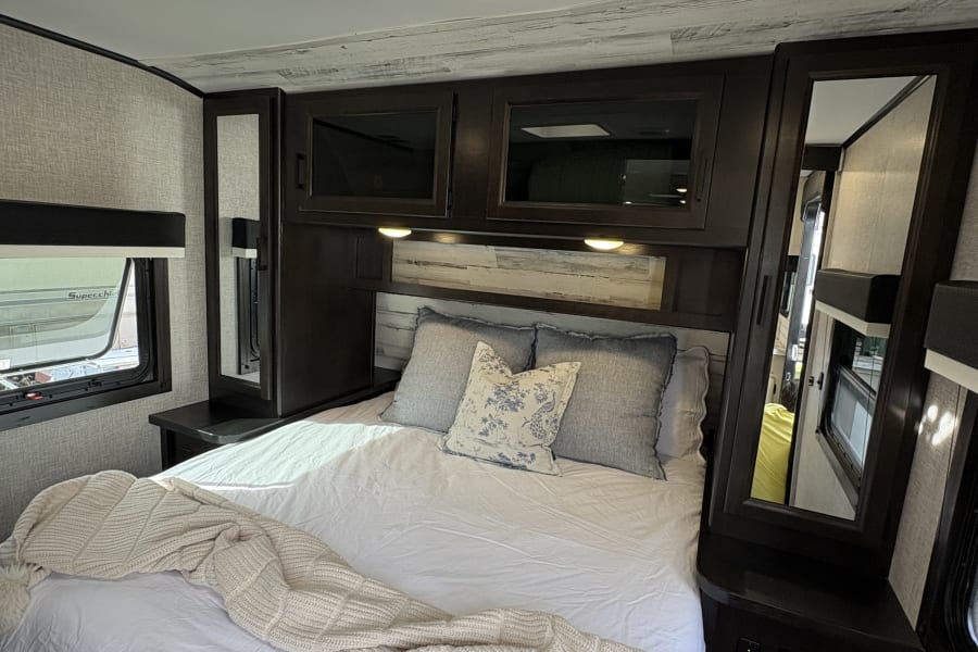 Master Bedroom with storage and charging features. 