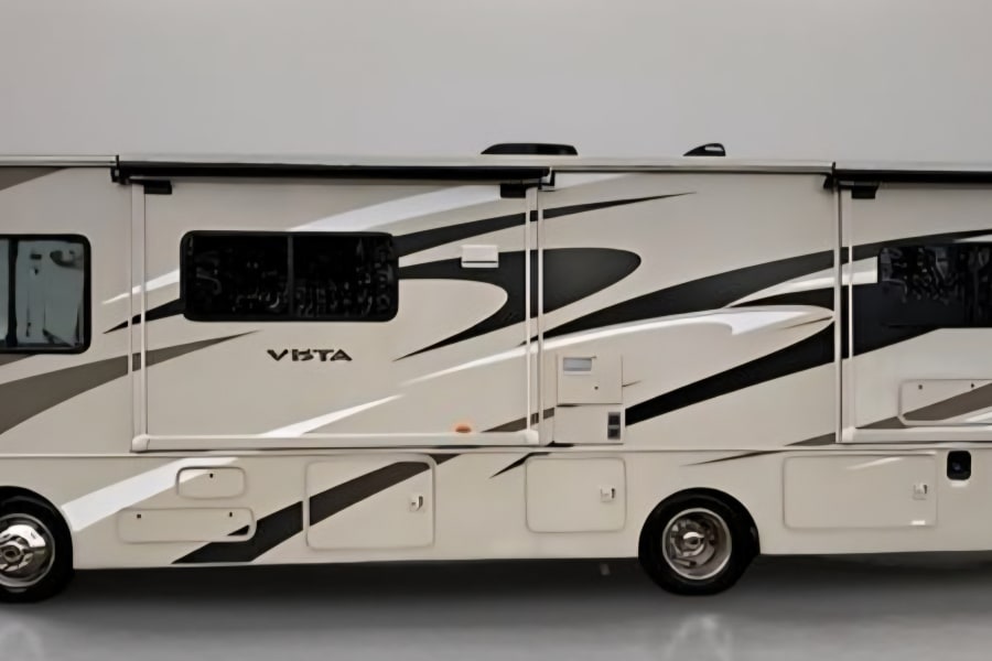This light-colored RV rental features dynamic dark and light grey stripe graphics, ideal for travel adventures.