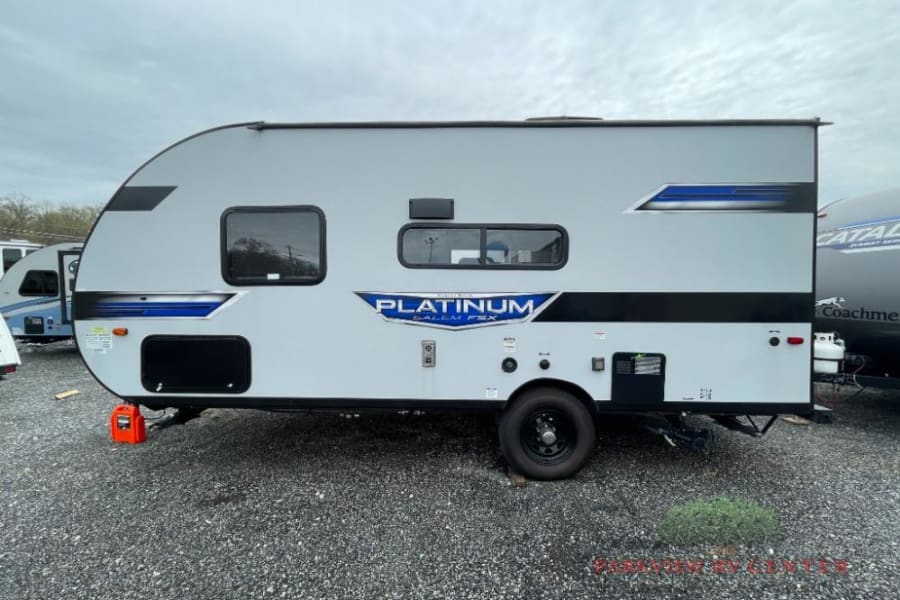 Light gray Platinum Salem FSX travel trailer, with blue accents, ready for your RV rental adventure or road trip.