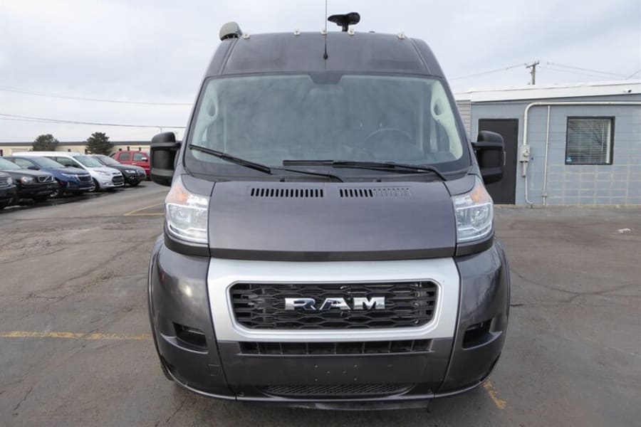 Front view of a dark grey Ram ProMaster van, an ideal rv rental for spacious travel adventures.