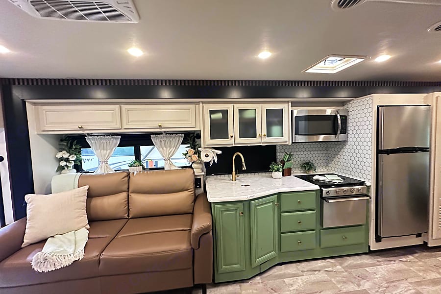 Flair kitchen with green cabinetry and lounge seating