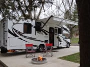 White RV rental with extended awning, chairs