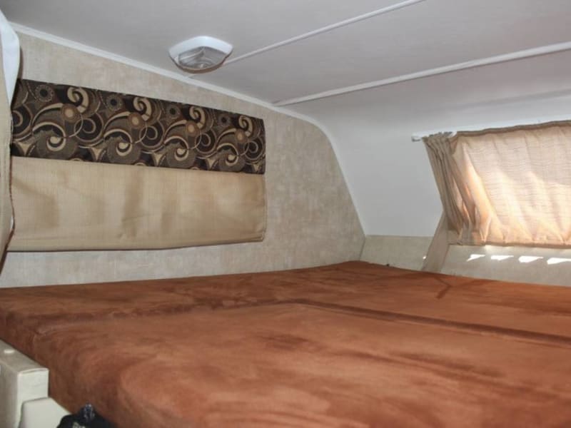 Large queen bed above the cab.