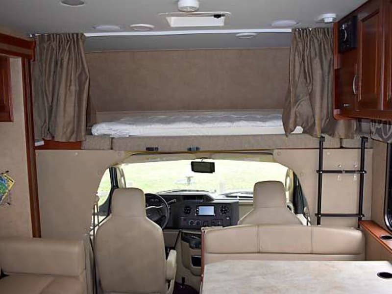 Sleeping area above driver, dinette and sofa