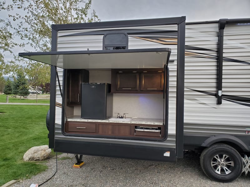 The outdoor kitchen area includes a Refrigerator (only works on 110vac) a small sink, and a 2 burner camp stove