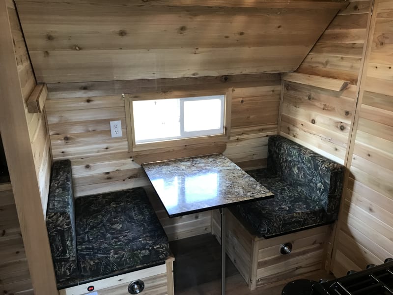 Side dinette and bunk bed in raised position.