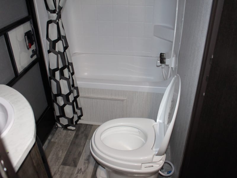 Spacious full bathroom with exterior door access. 
