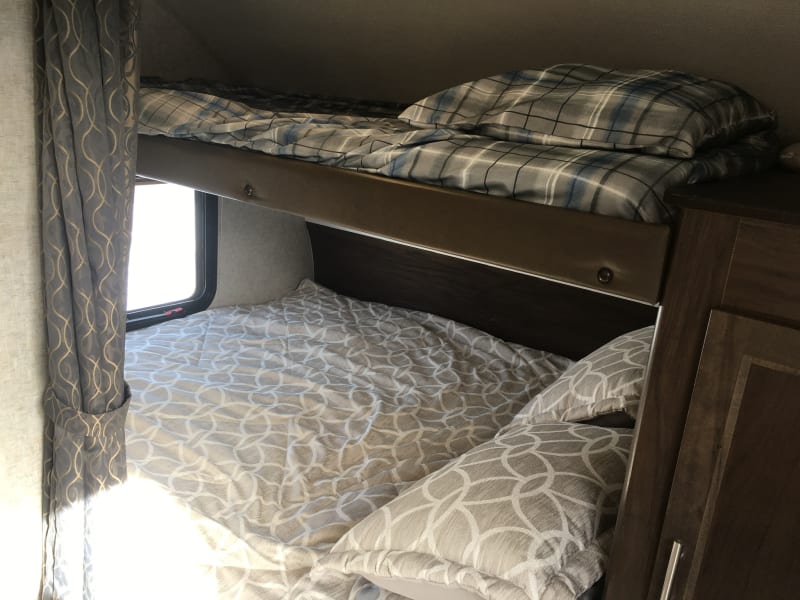 front queen bed with overhead single bunk