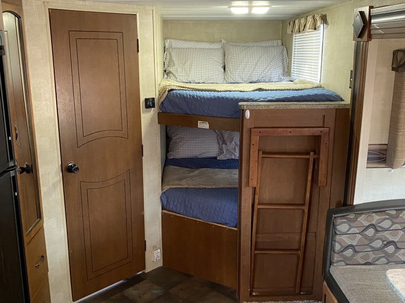 Full over full bunk beds, complete with ladder for easy access to top bunk.